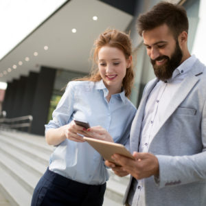 Business people or businessman and businesswoman working outdoor Trabajadores usando Clicktec